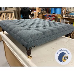 Glenmore Deep Buttoned Footstool with Border 122 x 122cm (48 x 48") COM Moons Wool Herringbone Dark Teal - Corner Stud Trim - 7ins Castor Mahogany Leg 8014 Glenmore Deep Buttoned Footstool with Border 122 x 122cm (48 x 48") COM Moons Wool Herringbone Dark Teal - Corner Stud Trim - 7ins Castor Mahogany Leg 8014