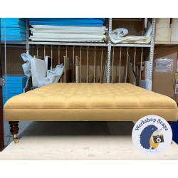 Glenmore Deep Buttoned Footstool with Border 122 x 122cm (48 x 48") House Cotton Mustard - Single Piped Trim - 7ins Castor Mahogany Leg 7179 Glenmore Deep Buttoned Footstool with Border 122 x 122cm (48 x 48") House Cotton Mustard - Single Piped Trim - 7ins Castor Mahogany Leg 7179